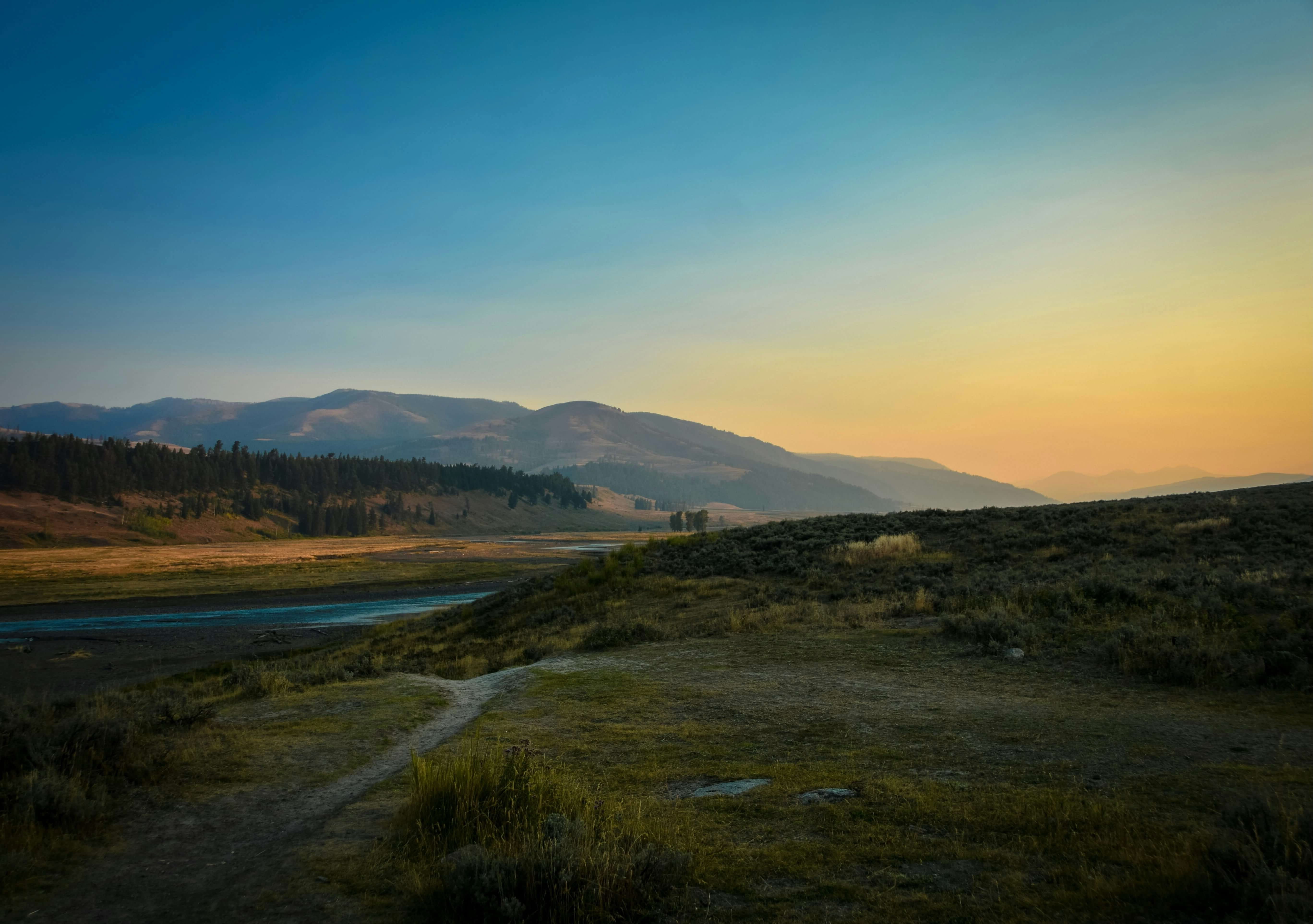 Rolling plains during sunset and a small mountain range in the background